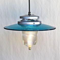 a blue light hanging from a ceiling fixture