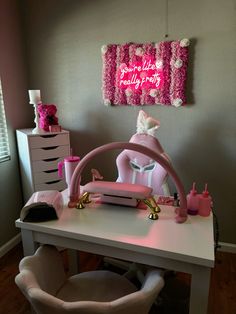 a desk with a pink chair and hello kitty decoration