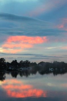 the sky is reflected in the calm water