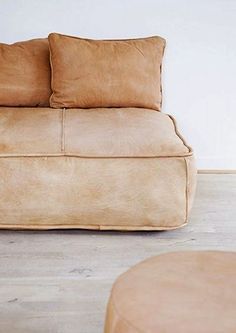 a couch with two pillows sitting on top of it