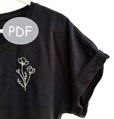 a black t - shirt with white flowers on it and the word pdf written in front