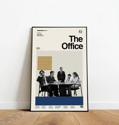 the office tv show poster on a wooden floor in front of a white wall with a black frame