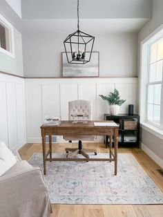 a living room with white walls and wood floors