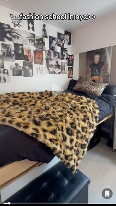 a bed room with a neatly made bed and lots of pictures on the wall behind it