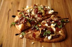 two slices of pizza sitting on top of a wooden cutting board