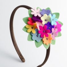 a close up of a headband made out of felt flowers on a white background