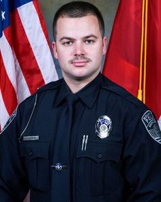 a police officer standing in front of flags