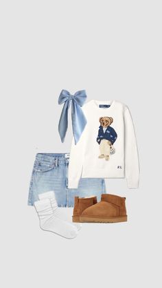 a teddy bear sweater, jeans and booties are outfitted with a blue bow