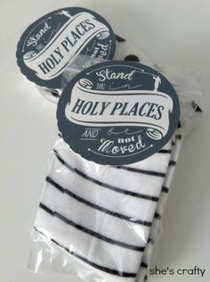 two white and black striped napkins in plastic packaging