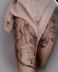 a woman's thigh with tattoos on it