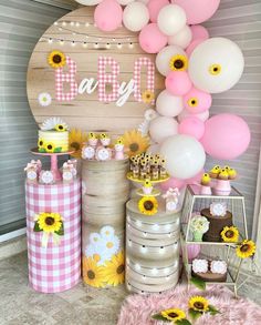 a baby shower party with sunflowers and balloons