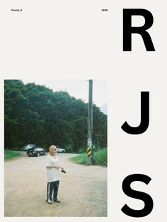 a woman standing in the middle of a dirt road next to a street sign that reads rj's