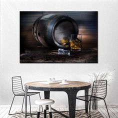 a table with two chairs and a wine glass on it in front of a barrel