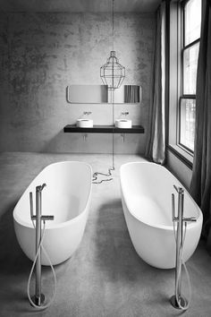 a large white bath tub sitting next to a window