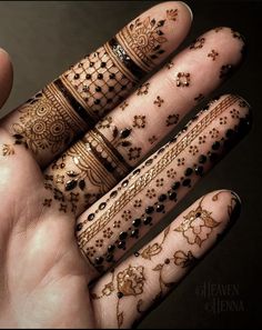 two hands with hendi designs on them