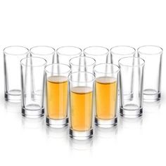 several shot glasses filled with liquid sitting next to each other