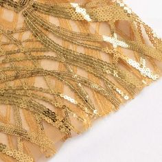 Gold Wave Sequin Sash Introducing a touch of opulence to your event decor, our Wave Embroidered Sequin Mesh Chair Sashes Bands are a captivating addition that elevates ordinary seating into extraordinary elegance. Crafted with meticulous attention to detail, these sashes seamlessly blend the richness of gold, creating a dynamic visual interplay that catches the eye and adds a touch of luxury to any occasion. The intricate wave embroidery, delicately woven with sequins on a mesh base, brings a textured depth that shimmers and dances with every movement. Gold Embroidered Sequin Mesh Sash Enhance the ambiance of weddings, galas, and celebrations with these chair sashes that go beyond mere accessoriesthey are works of art that transform chairs into stunning focal points. Each sash features a p Gold Embroidered Fabric For Festive Ceremony, Gold Embroidered Fabric For Ceremony And Festive Occasions, Festive Gold Embroidered Fabric For Ceremony, Gold Sequin Fabric For Banquet, Glamorous Gold Sequin Fabric For Banquet, Glamorous Gold Sequin Fabric For Banquets, Gold Embroidered Fabric For Party Festivals, Gold Sequin Fabric For Festive Holidays, Gold Embroidered Fabric For Festivals And Parties