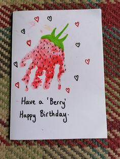 a handprinted card with a strawberry on it that says have a berry happy birthday