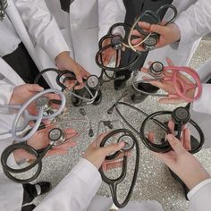 a group of people in white lab coats holding scissors and stethoscopes