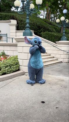 an image of a stuffed animal that is standing in front of a lamp post and stairs