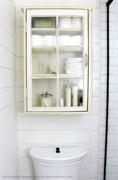 a bathroom cabinet with towels and other items in it