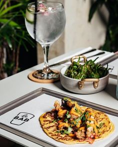 a plate with food on it next to a glass of water and some other items