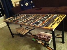 a coffee table made out of books and magazines on top of a carpeted floor