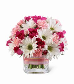 a vase filled with lots of pink and white flowers