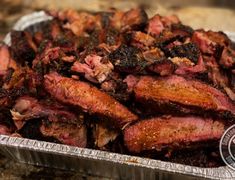 the meat is cooked and ready to be served in the tin foil container on the counter