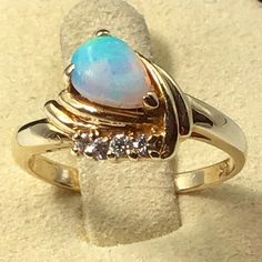 This Exquisite Ring Boasts A Stunning 14k Yellow Gold Band Adorned With A Beautiful Multicolor Opal And Four Sparkling Diamonds. The Ring Is A Size 5.25. The Opal And Diamonds Are Set In A Striking Arrangement That Highlights Their Natural Beauty. The Ring Is Perfect For Any Special Occasion Or As A Unique Addition To Your Jewelry Collection. Opal And Diamond Ring, Sparkle Diamonds, Gold Band, Womens Jewelry Rings, Gold Bands, Natural Beauty, Diamond Ring, Jewelry Collection, Special Occasion