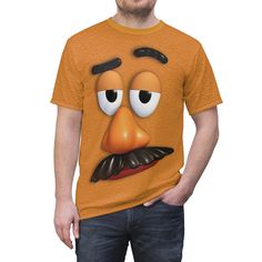 a man wearing an orange t - shirt with the face of a cartoon character on it