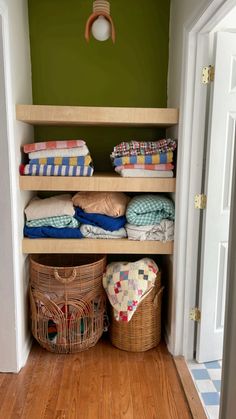 a closet with baskets and blankets in it