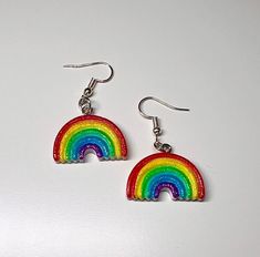 Add a pop of color to your outfit with these beautiful Rainbow Earrings. The 3-D design gives them a unique and playful touch, while the long ear wire closure ensures they stay securely in place. They also come with clear earring backs (not pictured). Handmade with love, these earrings are perfect for expressing your bohemian style and love for the LGBTQ community. The sparkling rainbow and gold accents will catch the light and make a bold statement. Don't miss out on this one-of-a-kind piece of Festival Earrings, Clear Earrings, Rainbow Earrings, Beautiful Rainbow, Ear Wire, Boho Stil, Gold Accents, Earring Backs, Gifts For Friends