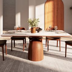 a dining room table with chairs and a vase on the table in front of it