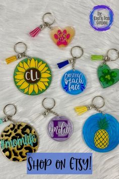 six different key chains with the words shop on etsy