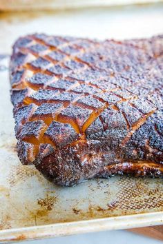 a piece of meat sitting on top of a wooden cutting board