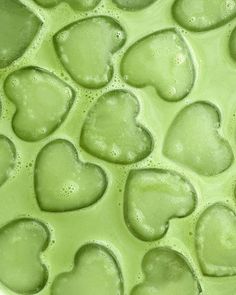 green liquid in the shape of hearts on a white surface