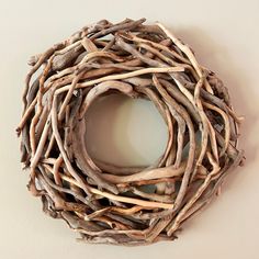 a wreath made out of driftwood is hanging on the wall