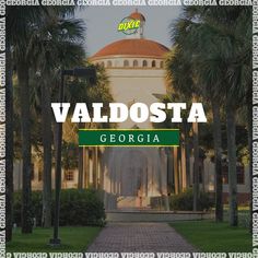 the words valdosta in front of palm trees and a building with a fountain