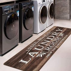 a laundry room with washers and dryer in it