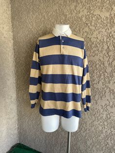 "Vintage striped long-sleeve shirt. Made by Chesterfield. Men Size Xl Made in the USA 50% Cotton and 50% Polyester. The shirt does have some wear due to its age, a couple of very tiny holes, and the collar has age spots, but it still has a lot of life left to it. Measurements laying flat Armpit to armpit 22\" (44\" total) From the top of the shoulder to the bottom of the sleeve cuff 31\" Total length of shirt 28\" Items are shipped out within 1-2 business days. If you have any questions please f Fall Long Sleeve Shirt With Striped Collar, Striped Long Sleeve Shirt For Fall, Blue Striped Long Sleeve Top, Blue Horizontal Stripe Long Sleeve Top, Blue Long Sleeve Tops With Horizontal Stripes, Blue Long Sleeve Top With Horizontal Stripes, Long Sleeve Cotton Shirt With Horizontal Stripes, Classic Striped Crew Neck Shirt, Classic Long Sleeve Tops With Striped Collar