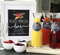 a table topped with wine glasses filled with fruit next to a sign that says merry mimosa bar