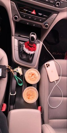 the interior of a car with cupcakes and other items