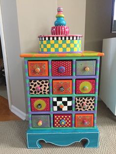 a multicolored dresser with lots of drawers