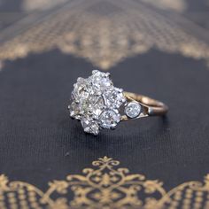 Super charming, super beautiful, and incredibly sparkly antique cluster ring, set wit the chunkiest and most lively old cut diamonds! The central diamond is showcased stunningly well in the surround of chunky old mine cut diamonds. In yellow gold, all the diamonds just pop! Low set on the finger, this ring is ideal for daily wear, and what a stunning and unique engagement ring this would make. Just a classically styled ring from the Victorian era. 14kt yellow gold, size 7.50, and fully sizable. Cluster Diamond Ring With Rose Cut Diamonds, Victorian Style White Diamond Ring, Dazzling Cluster Diamond Ring With Single Cut Diamonds, Diamond Cluster Ring With Rose Cut Diamonds, Dazzling Diamond Cluster Ring With Single Cut Diamonds, White Diamond Cluster Ring With Rose Cut, Victorian Cluster Ring With Brilliant Cut In Diamond White, Cluster Rose Cut Diamond Rings, Antique Brilliant Cut Diamond Cluster Ring