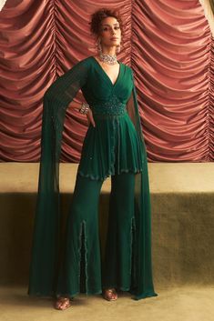 Elevate your style with this emerald green embellished peplum top, paired with chic tailored pants. The intricate embellishments add a touch of sophistication, while the flattering silhouette of the peplum creates a modern yet elegant look, perfect for festive occasions and special gatherings. Peplum Blouse Indian, Peplum Top With Pants, Subtle Embroidery, Top With Pants, Mehendi Ceremony, Pant For Women, Vacuum Storage, Ready To Wear Saree, Indian Wedding Wear