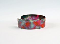 This etched copper dragonfly bangle bearing imagery of repeated dragonflies has been heat treated to create a vibrant multicoloured patina: this will deepen over time. I have developed a technique of literally 'painting' with a flame to manipulate the shape and direction of the colours. Although there is a degree of control, each piece is unique, as the colour patina cannot be replicated exactly.In holistic medicine, copper claims to have many health benefits: 'Copper has been used to promote he Adjustable Multicolor Patina Jewelry, Bronze Wearable Art Cuff Bracelet As Gift, Green Patina Bracelet As A Gift, Bronze Patina Bracelets As A Gift, Green Patina Bracelet As Gift, Green Bracelet With Patina As Gift, Green Bracelets With Patina As Gift, Copper Etched Bracelets As A Gift, Unique Patina Bangle As Gift