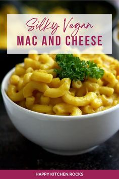 a white bowl filled with macaroni and cheese on top of a black counter