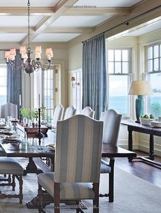 a dining room table with chairs and a chandelier