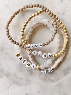 Seneca Stack – Cola Stacks Beaded Bracelets With Letters, Trendy Gold Beaded Bracelets With Heishi Beads, Everyday Beaded Stretch Bracelet In Gold, Gold Spiritual Name Bracelet With Letter Beads, Gold Stretch Bracelet With Letter Beads, Gold Heishi Beads Jewelry, Gold Spiritual Bracelets With Letter Beads, Gold Spiritual Bracelet With Letter Beads, Trendy Gold Bracelet With Round Beads